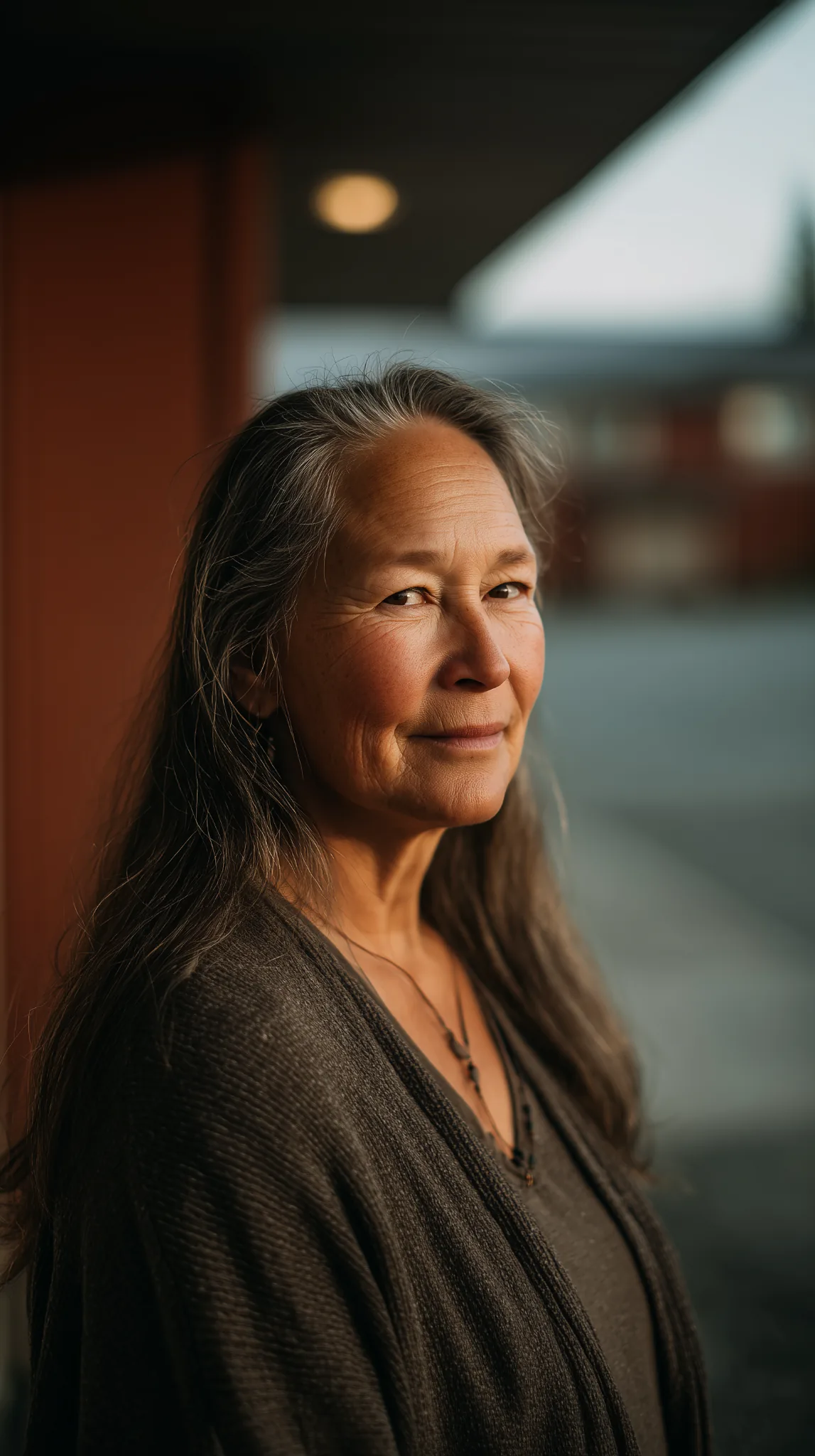 Portrait of an older woman standing outdoors in Prince George, British Columbia, looking calmly toward the camera.